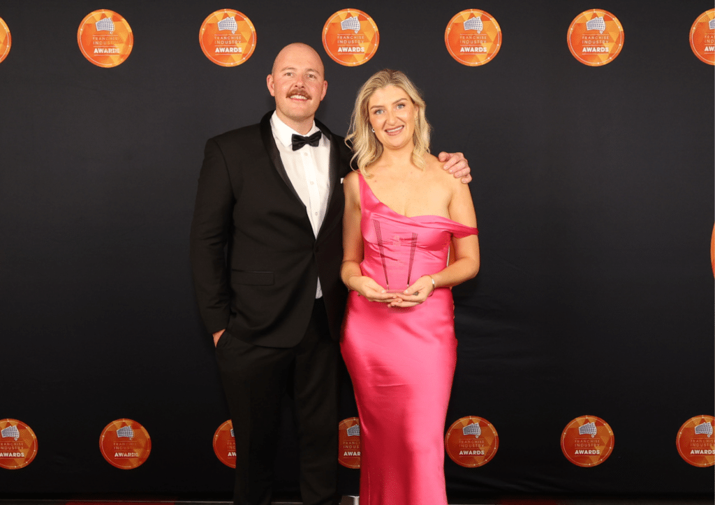 George Blackie and Sarah Ryan, Nurse Next Door Mackay, accepting their Single Unit Franchisee of the Year (Services), FIA 2026